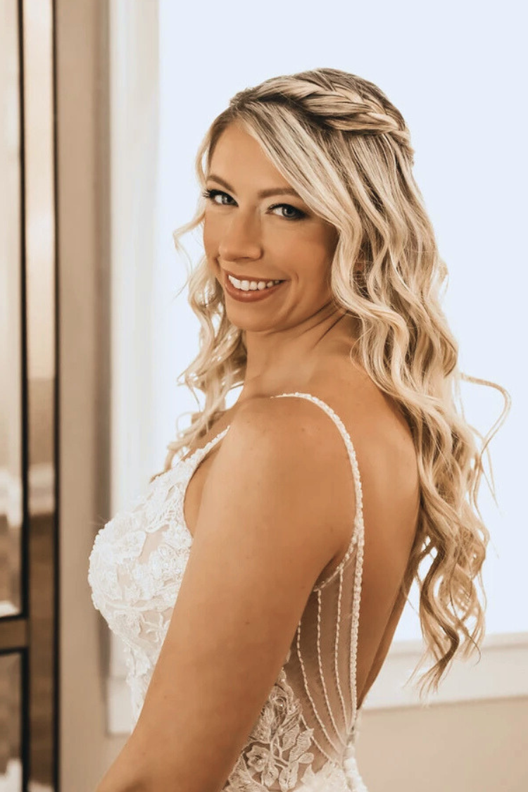 Glowing bride with romantic wedding hair and makeup by AD Artistry, featuring soft curls and natural glam