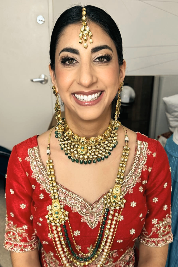 Happy bride displaying perfect bridal hair and makeup artistry by AD Artistry on her wedding day