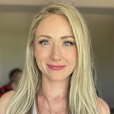 Bride with platinum blonde hair and natural glam makeup featuring soft pink lips and fluttery lashes