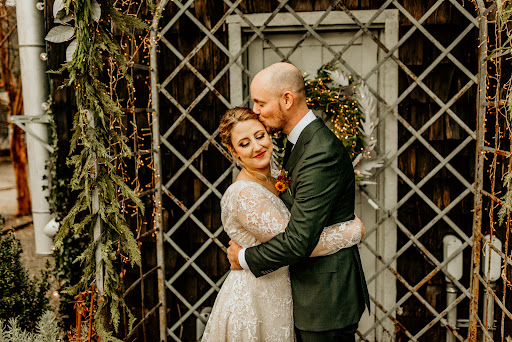 An AD Artistry bride being kissed by her husband